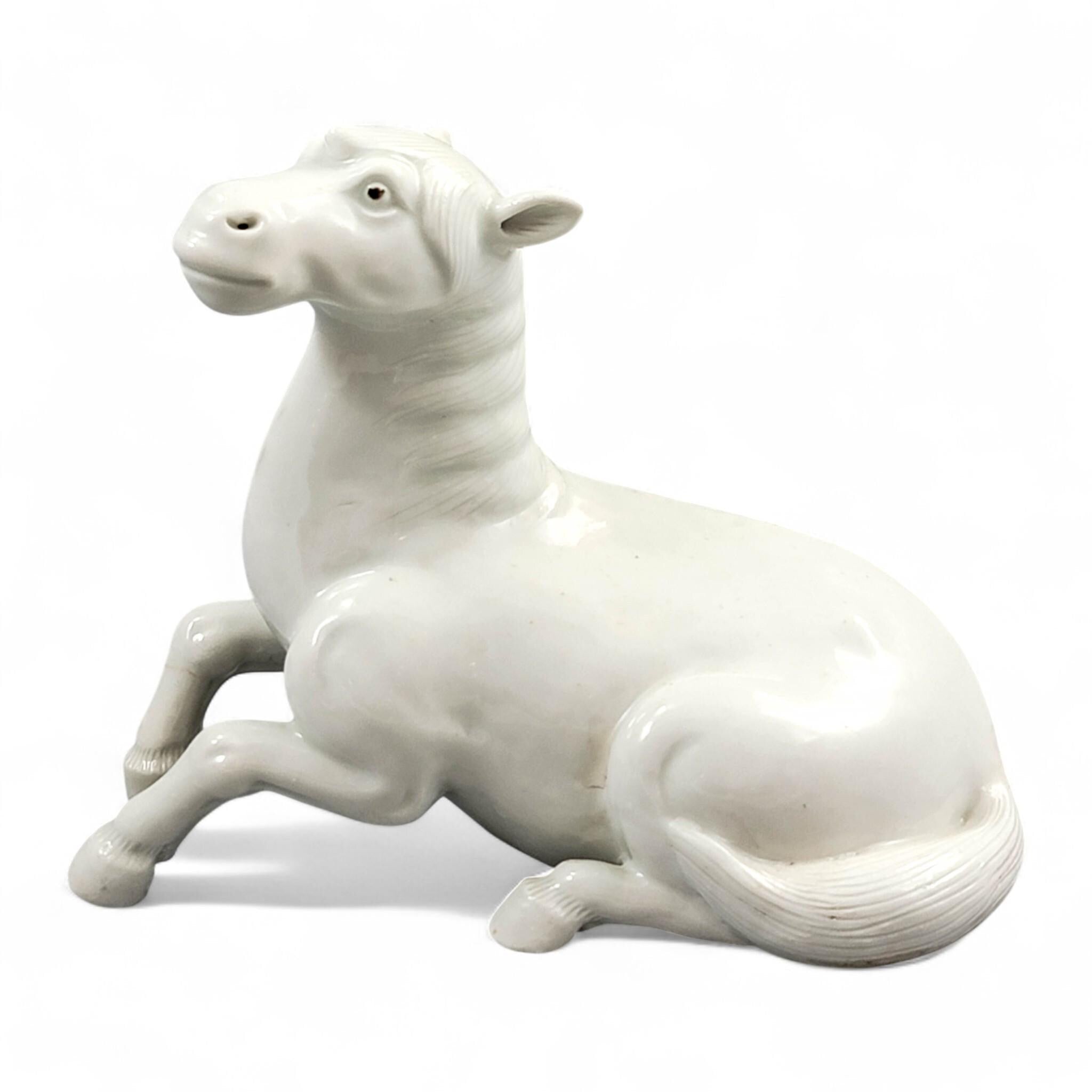 Hirado porcelain recumbent horse figurine, Mikawachi kilns Japanese white glazed sculpture, late Edo to Meiji period
