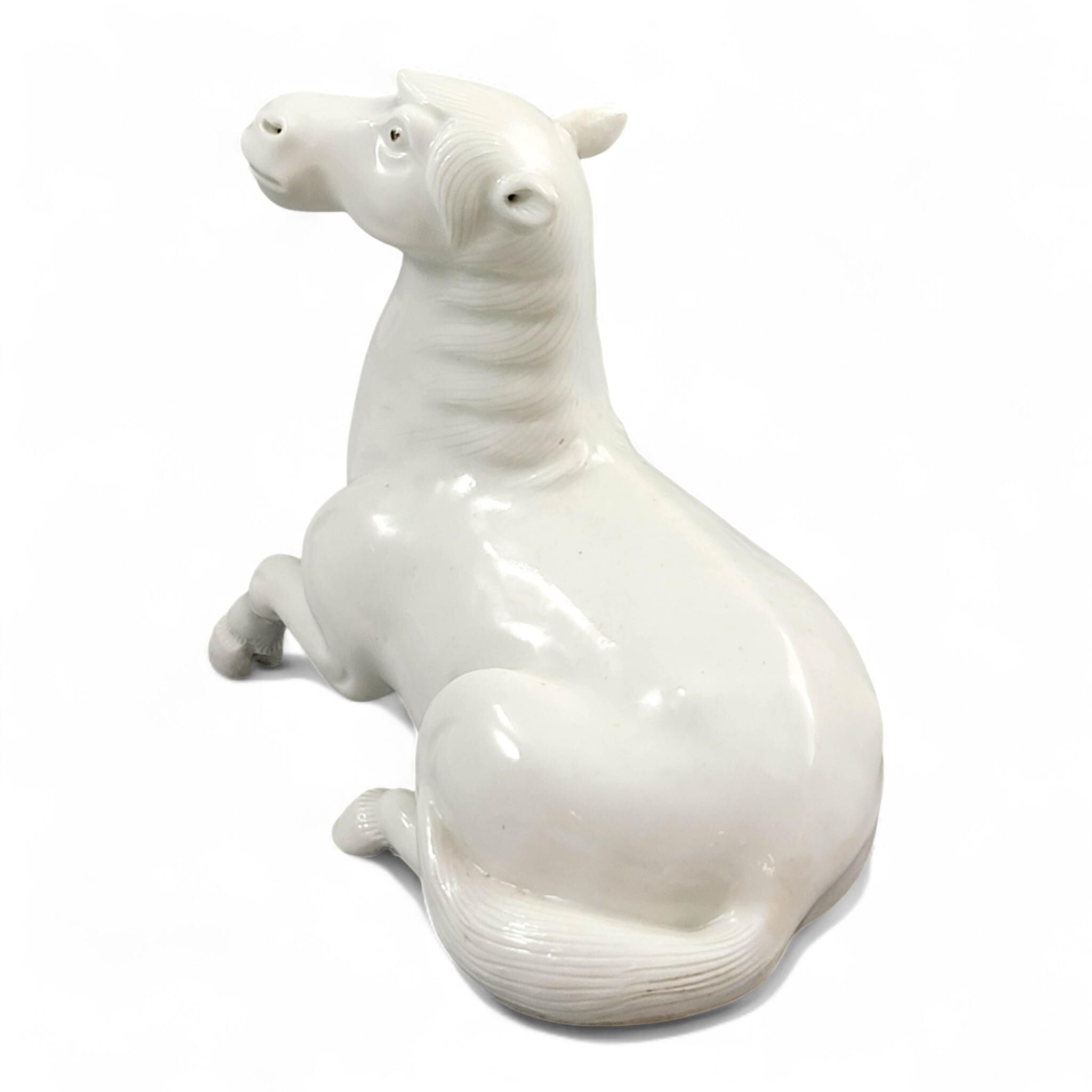 Hirado porcelain recumbent horse figurine, Mikawachi kilns Japanese white glazed sculpture, late Edo to Meiji period