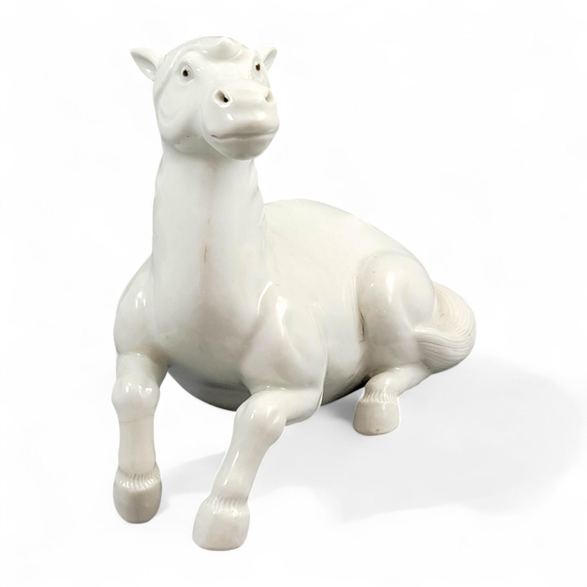 Hirado porcelain recumbent horse figurine, Mikawachi kilns Japanese white glazed sculpture, late Edo to Meiji period