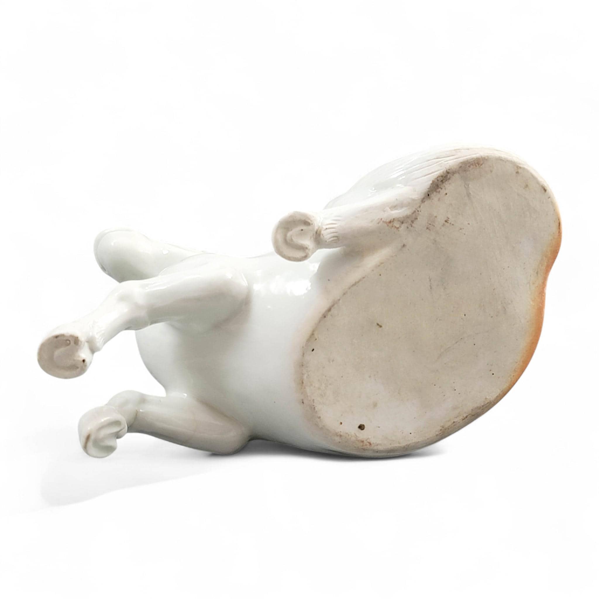 Hirado porcelain recumbent horse figurine, Mikawachi kilns Japanese white glazed sculpture, late Edo to Meiji period