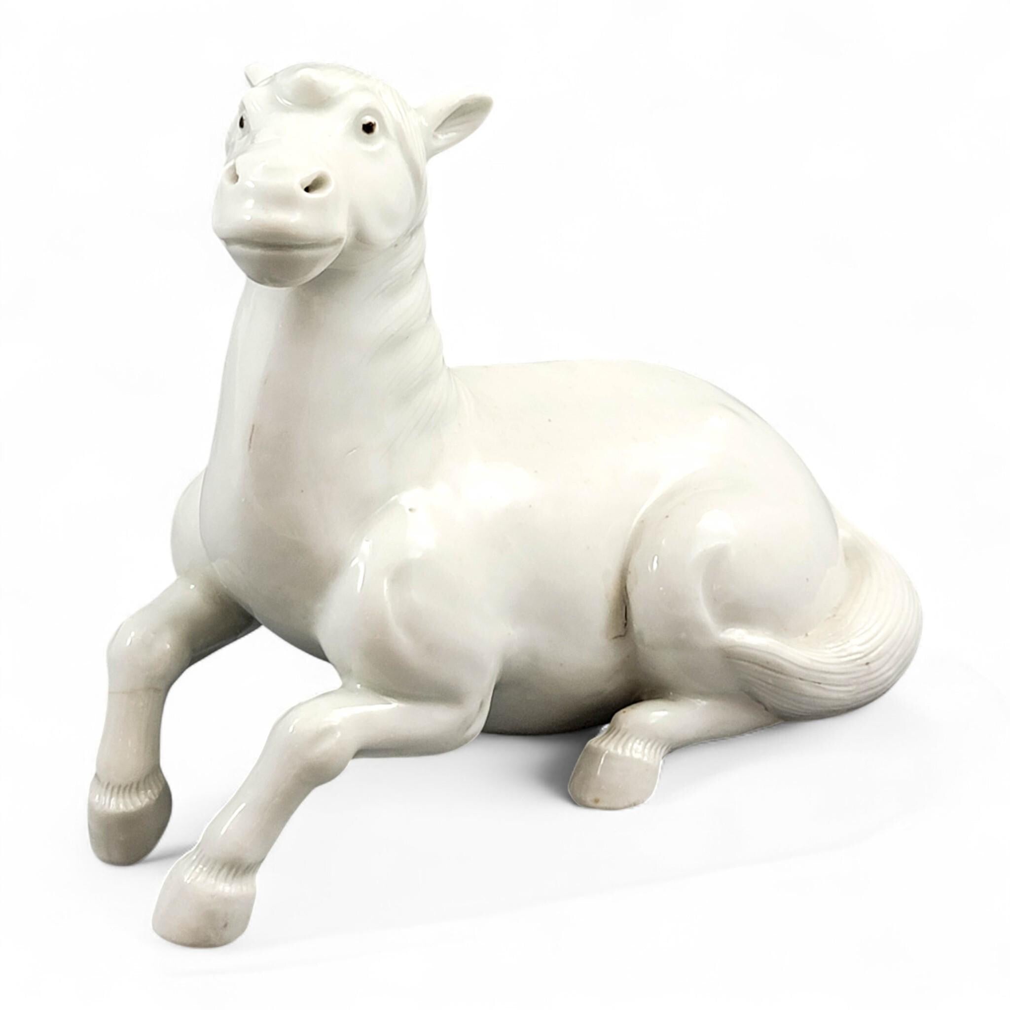 Hirado porcelain recumbent horse figurine, Mikawachi kilns Japanese white glazed sculpture, late Edo to Meiji period