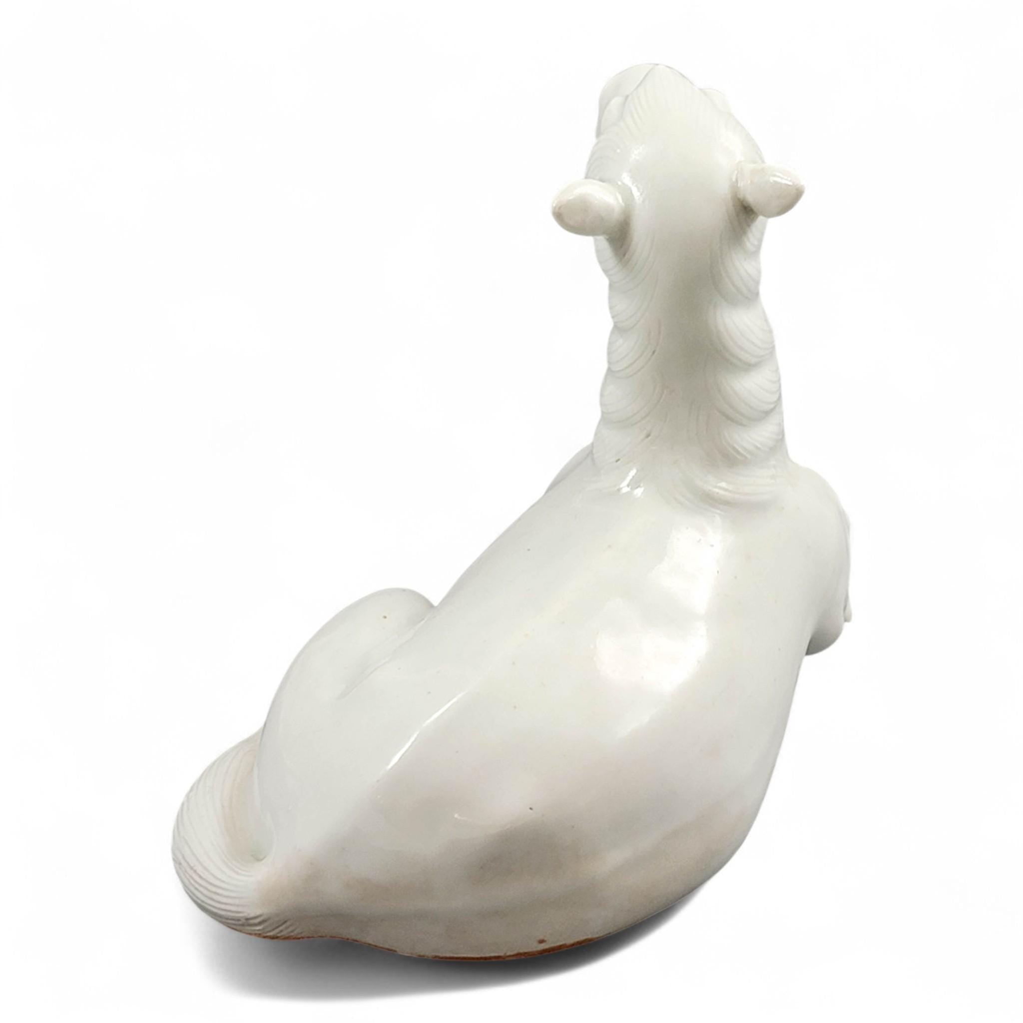 Hirado porcelain recumbent horse figurine, Mikawachi kilns Japanese white glazed sculpture, late Edo to Meiji period