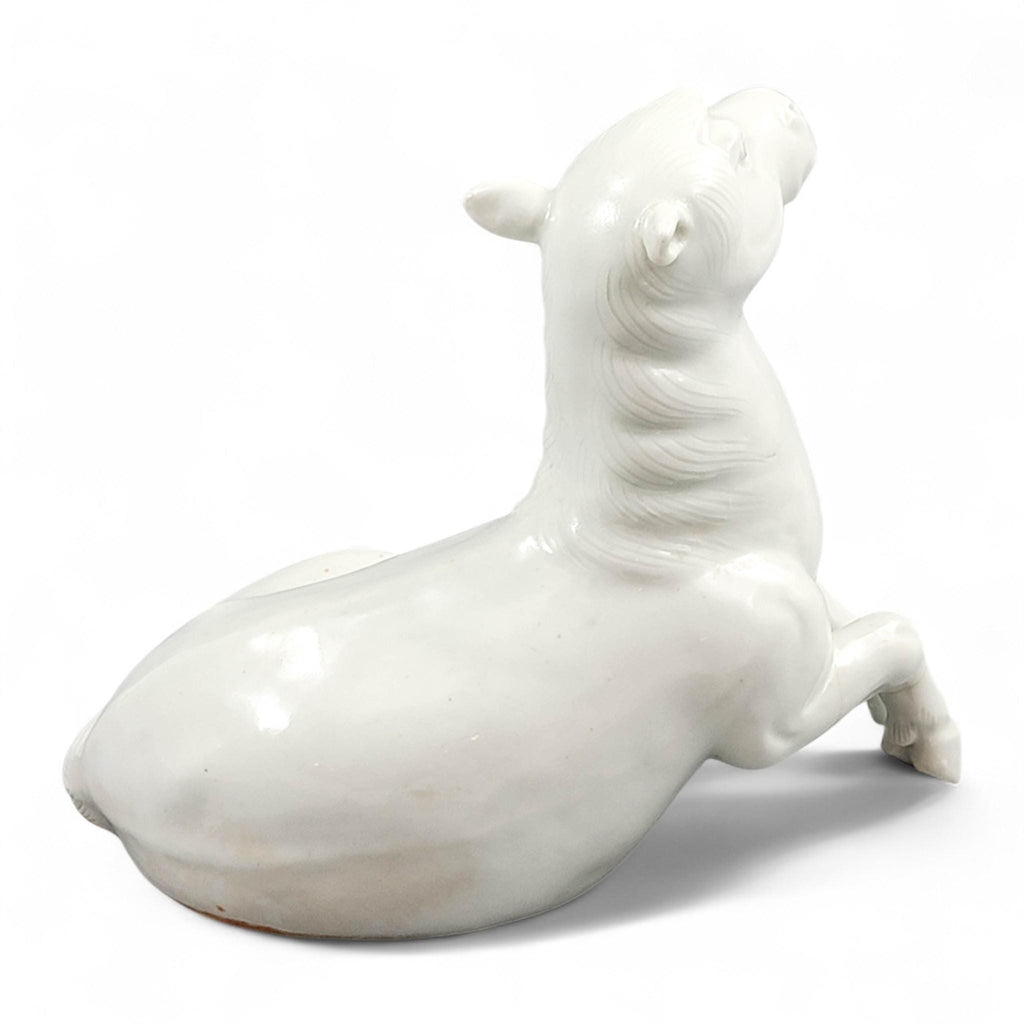 Hirado porcelain recumbent horse figurine, Mikawachi kilns Japanese white glazed sculpture, late Edo to Meiji period