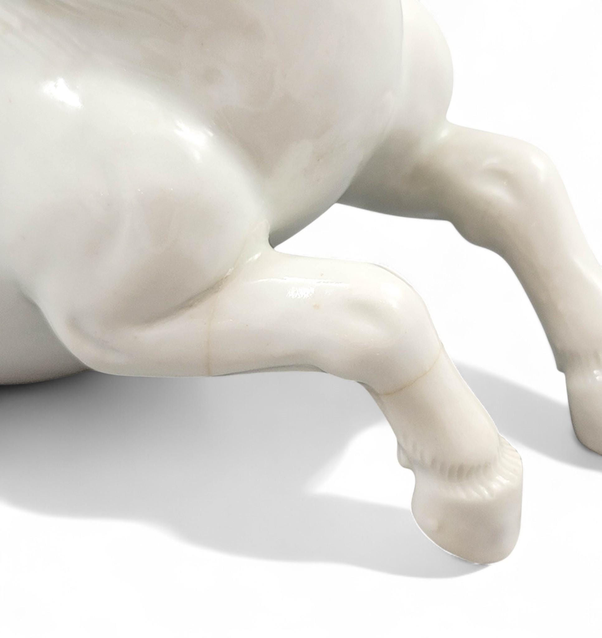 Hirado porcelain recumbent horse figurine, Mikawachi kilns Japanese white glazed sculpture, late Edo to Meiji period