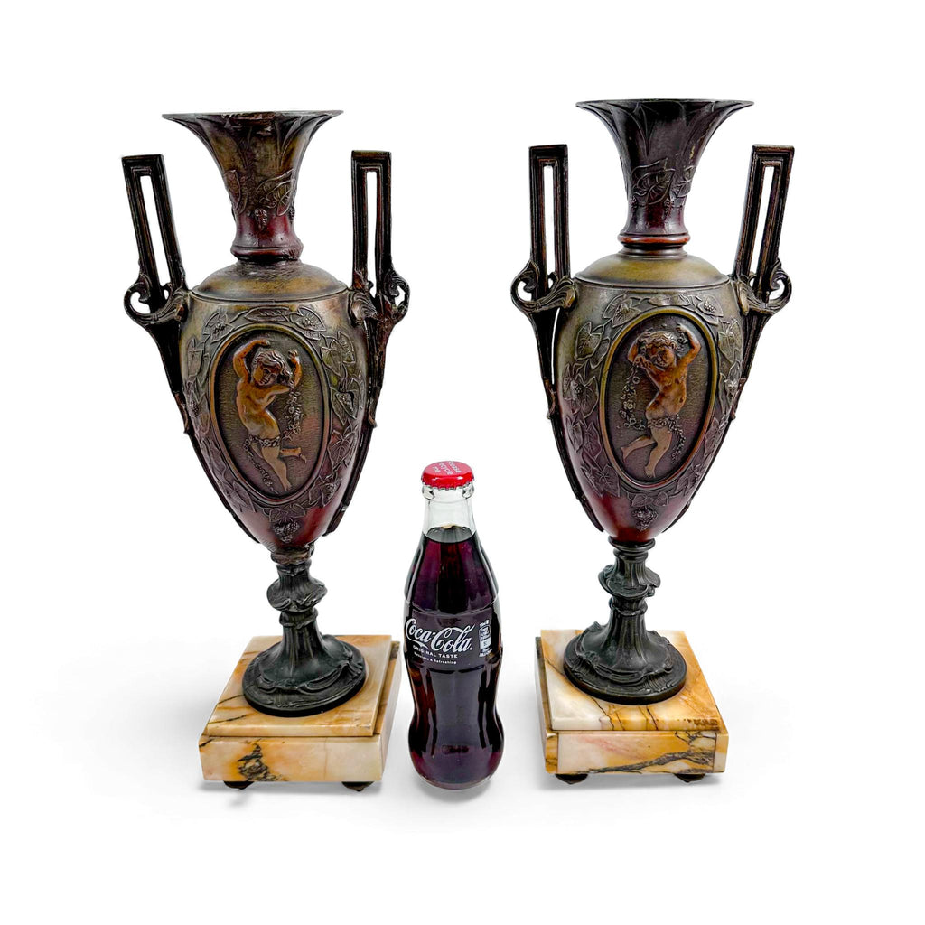 Pair of antique French Amphora vases, spelter with cherub relief, 19th century
