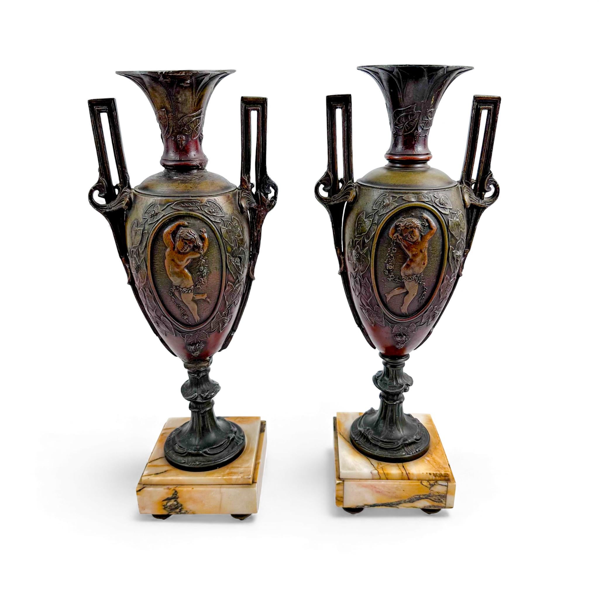 Pair of antique French Amphora vases, spelter with cherub relief, 19th century