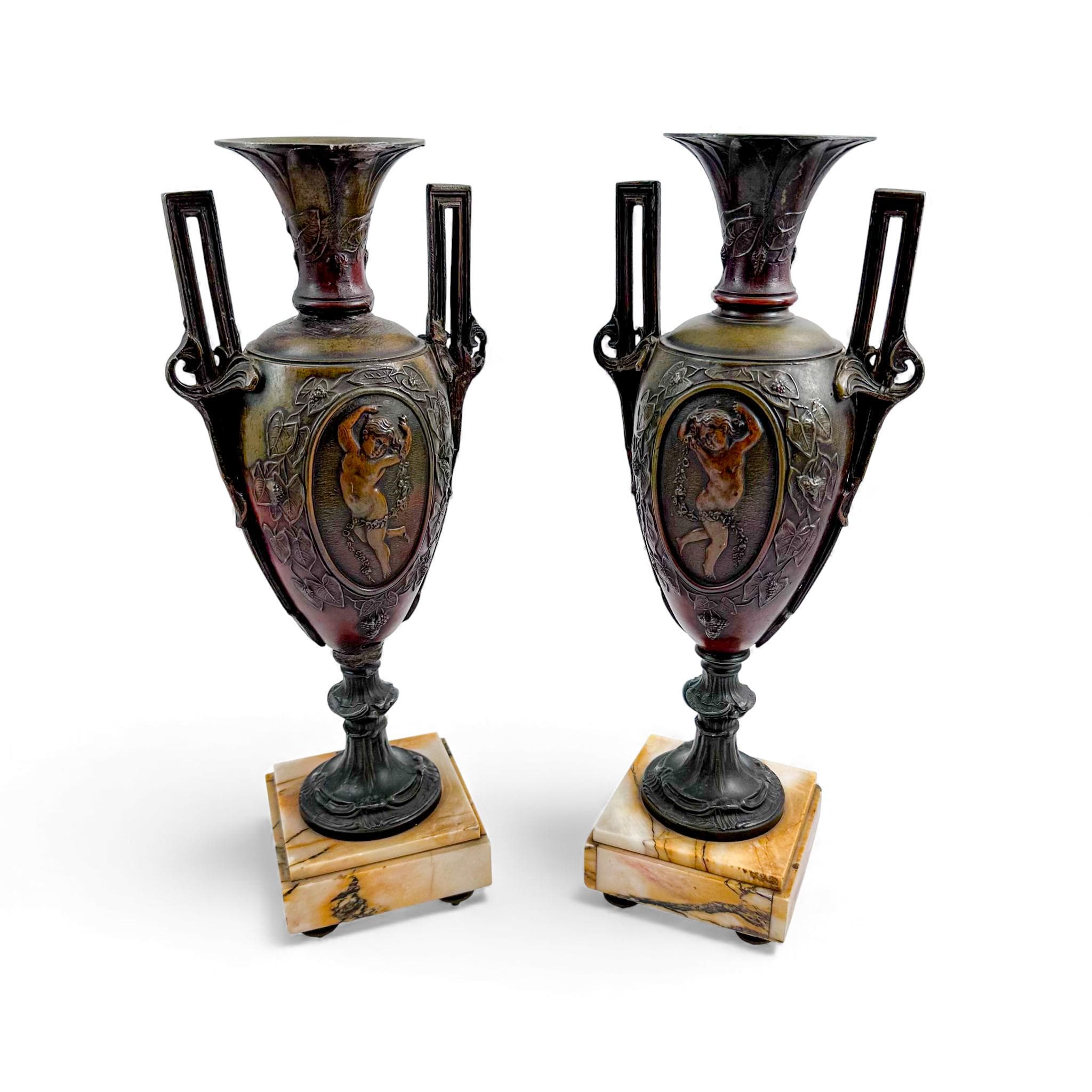 Pair of antique French Amphora vases, spelter with cherub relief, 19th century