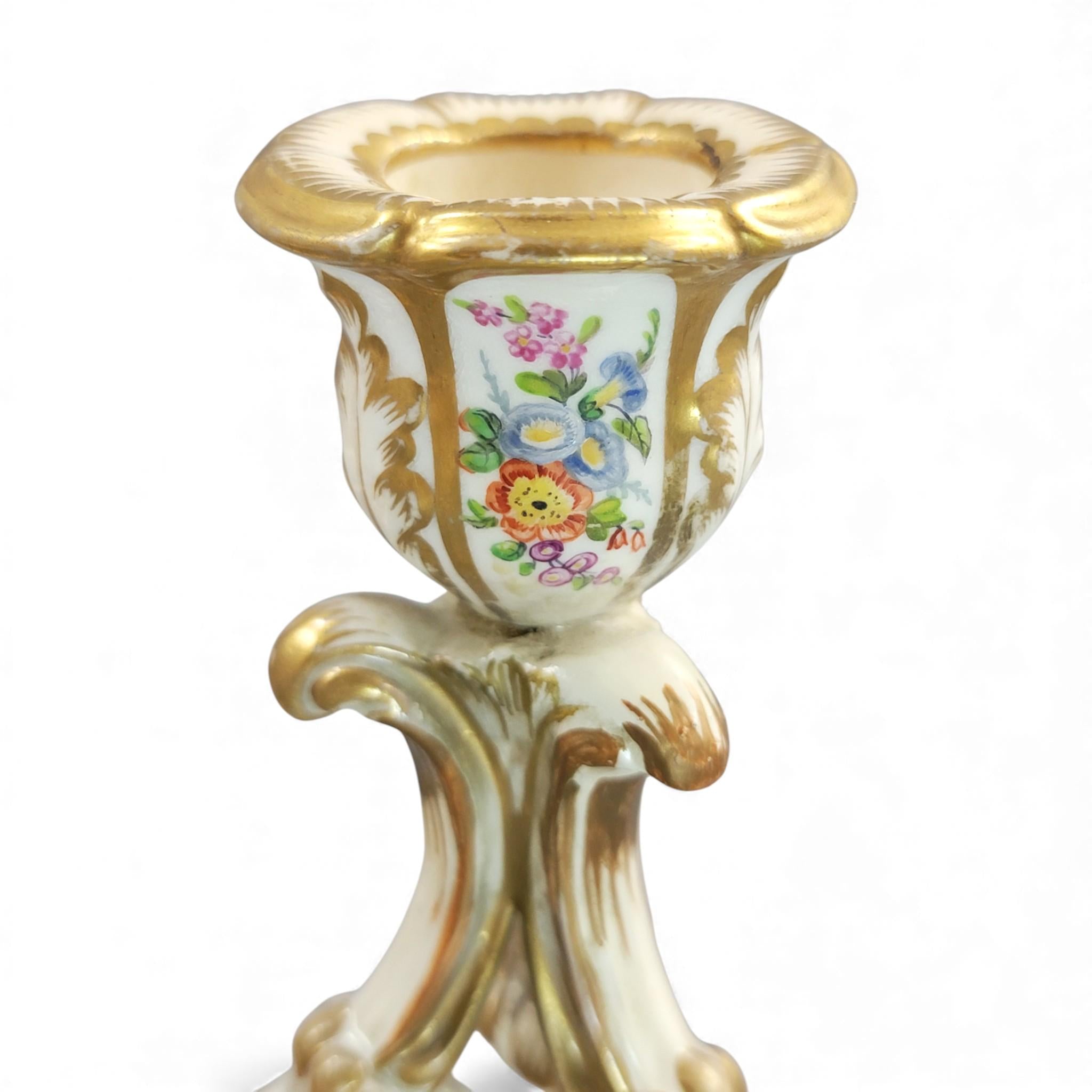 Pair of Derby rococo porcelain candlesticks c.1825–1830, hand-painted floral cups