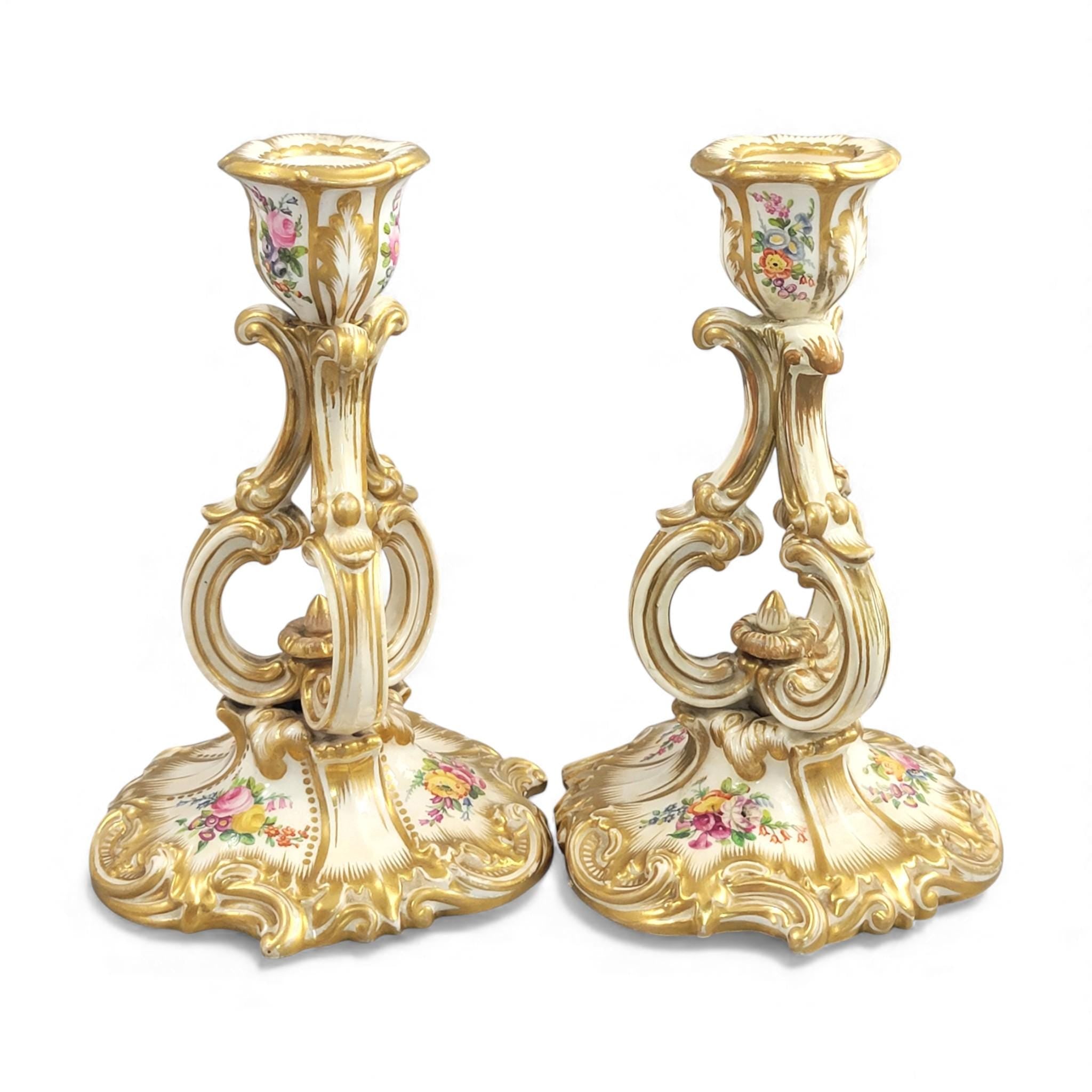 Pair of Derby rococo porcelain candlesticks c.1825–1830, hand-painted floral cups