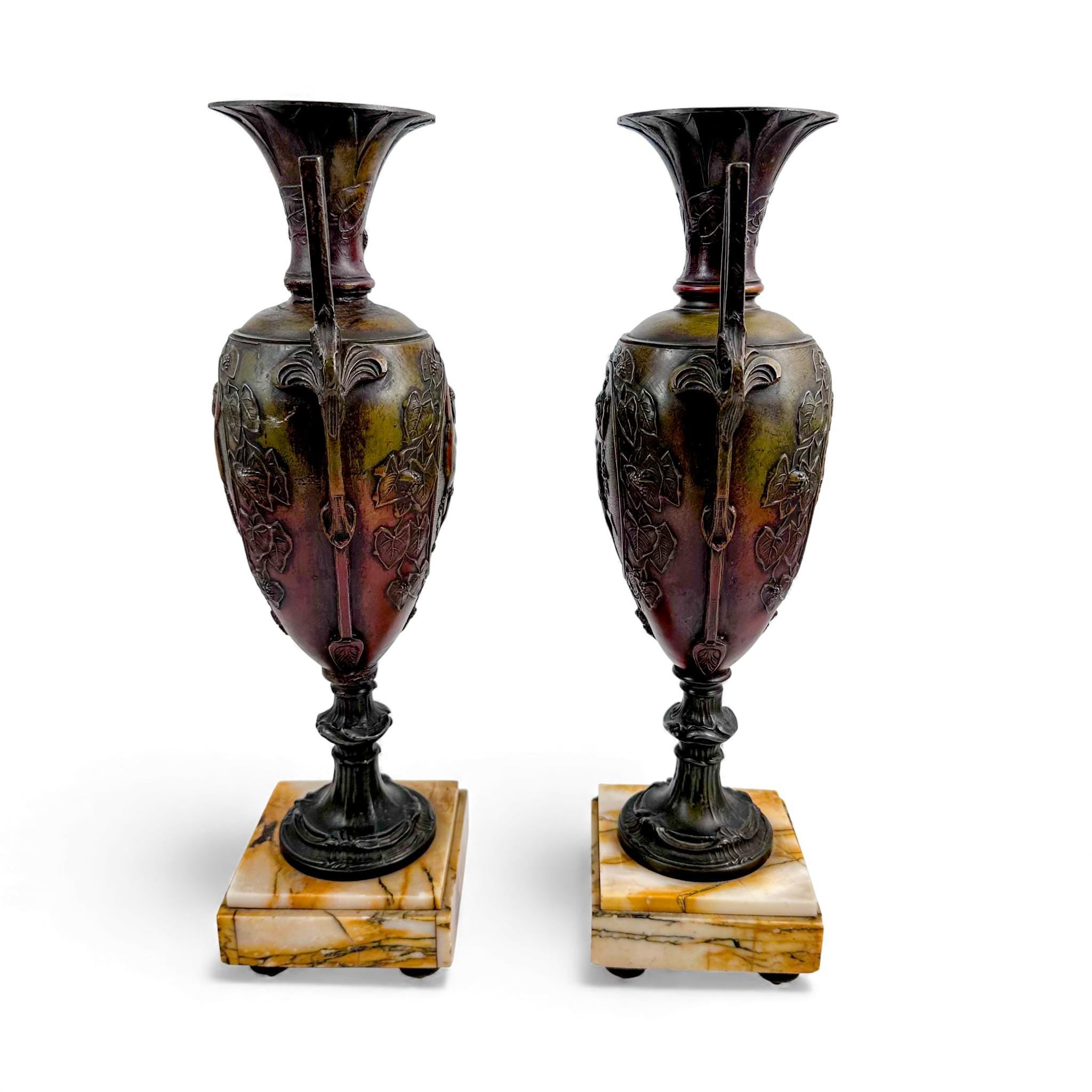 Pair of antique French Amphora vases, spelter with cherub relief, 19th century
