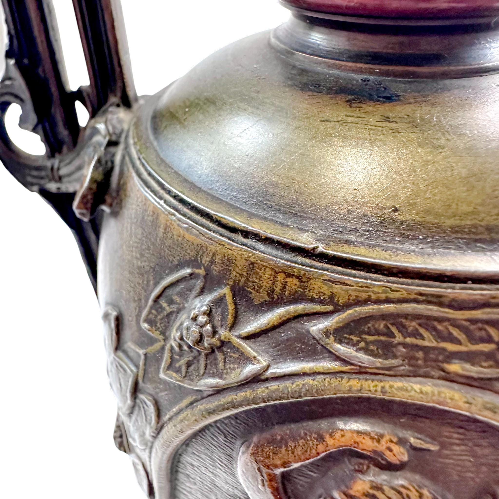 Pair of antique French Amphora vases, spelter with cherub relief, 19th century