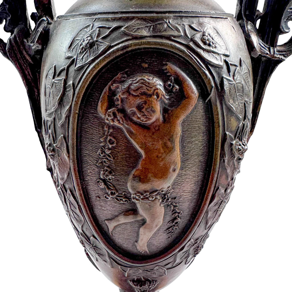 Pair of antique French Amphora vases, spelter with cherub relief, 19th century