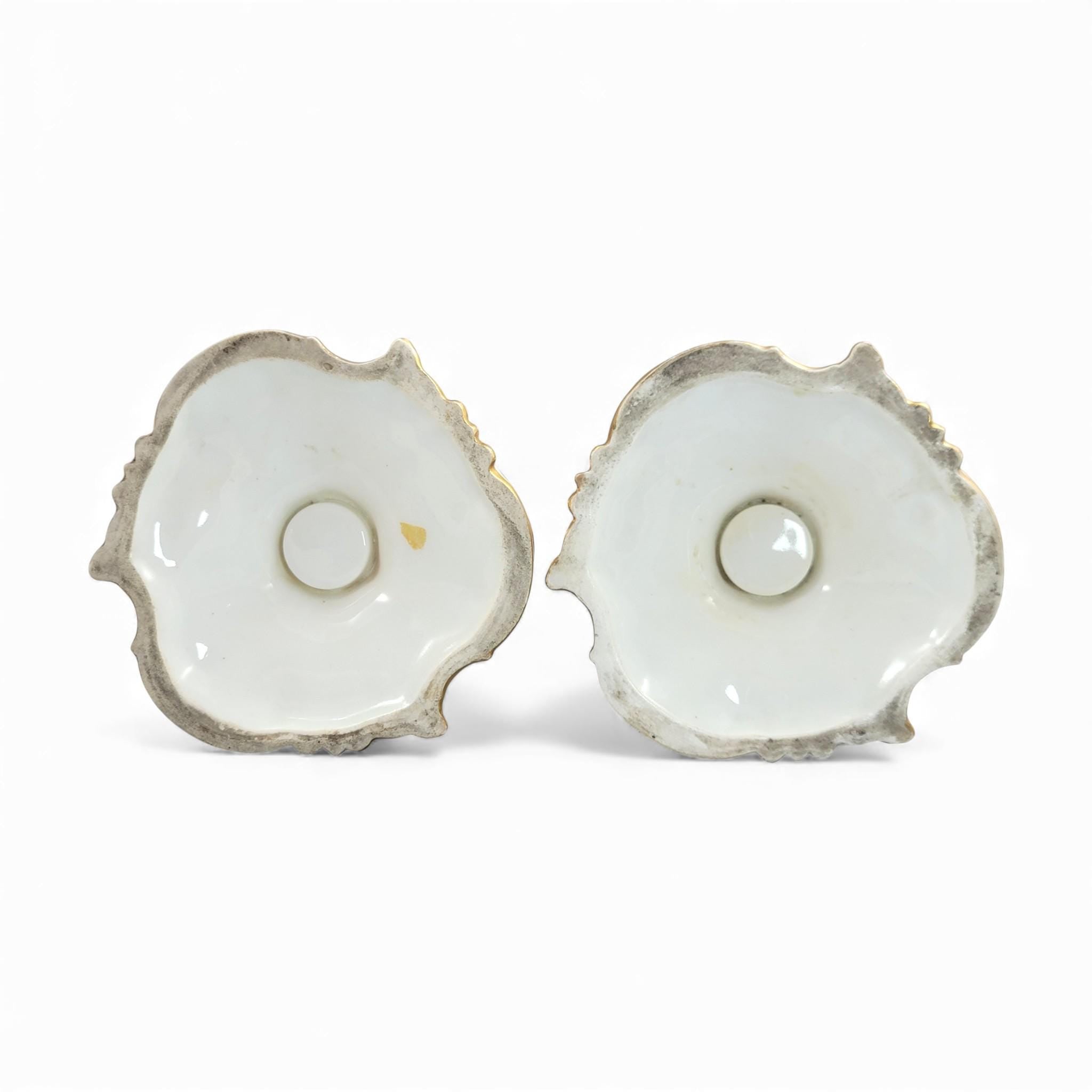 Pair of Derby rococo porcelain candlesticks c.1825–1830, hand-painted floral cups