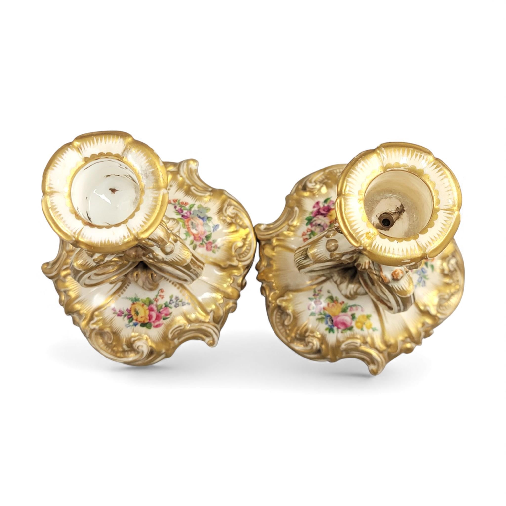 Pair of Derby rococo porcelain candlesticks c.1825–1830, hand-painted floral cups