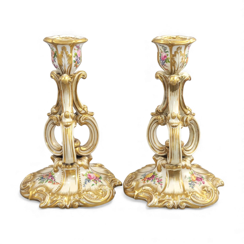 Pair of Derby rococo porcelain candlesticks c.1825–1830, hand-painted floral cups