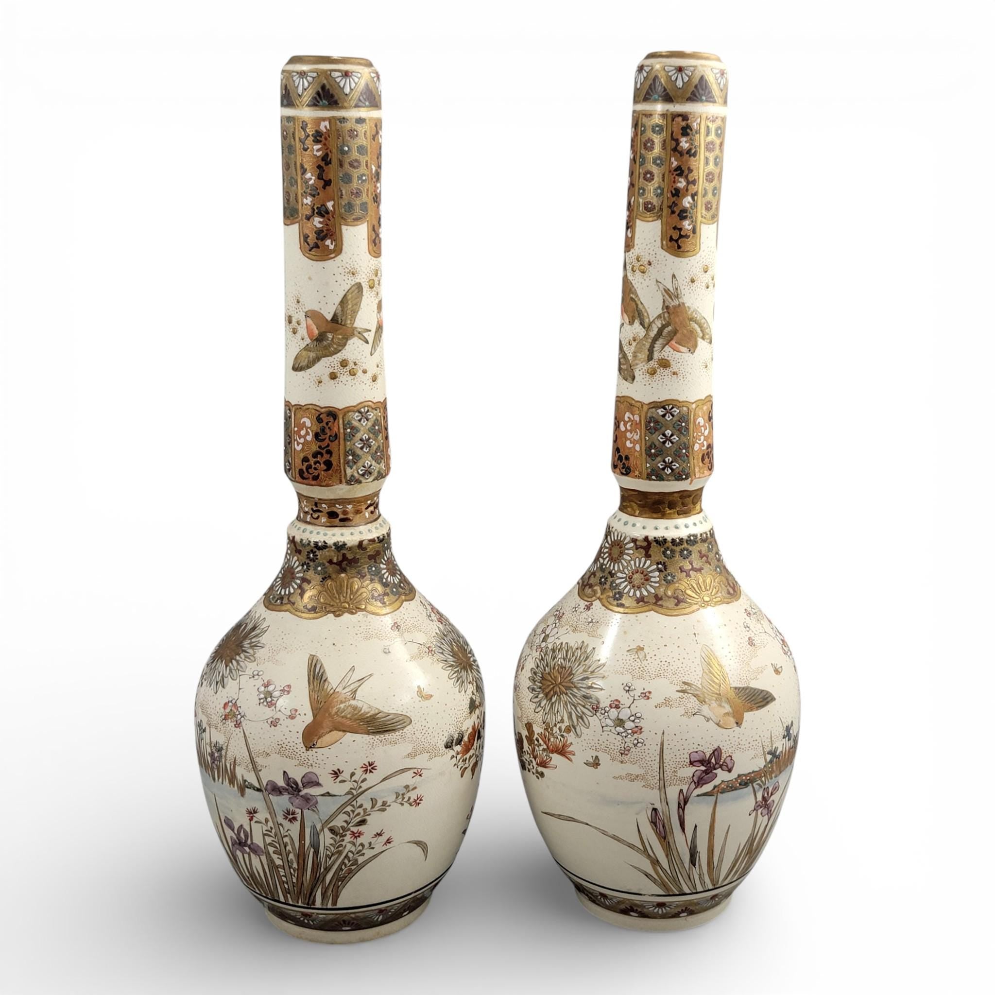 Rare pair of large Japanese Satsuma vases of elongated bottle form, dating to the Meiji period and standing approximately 38 cm high.