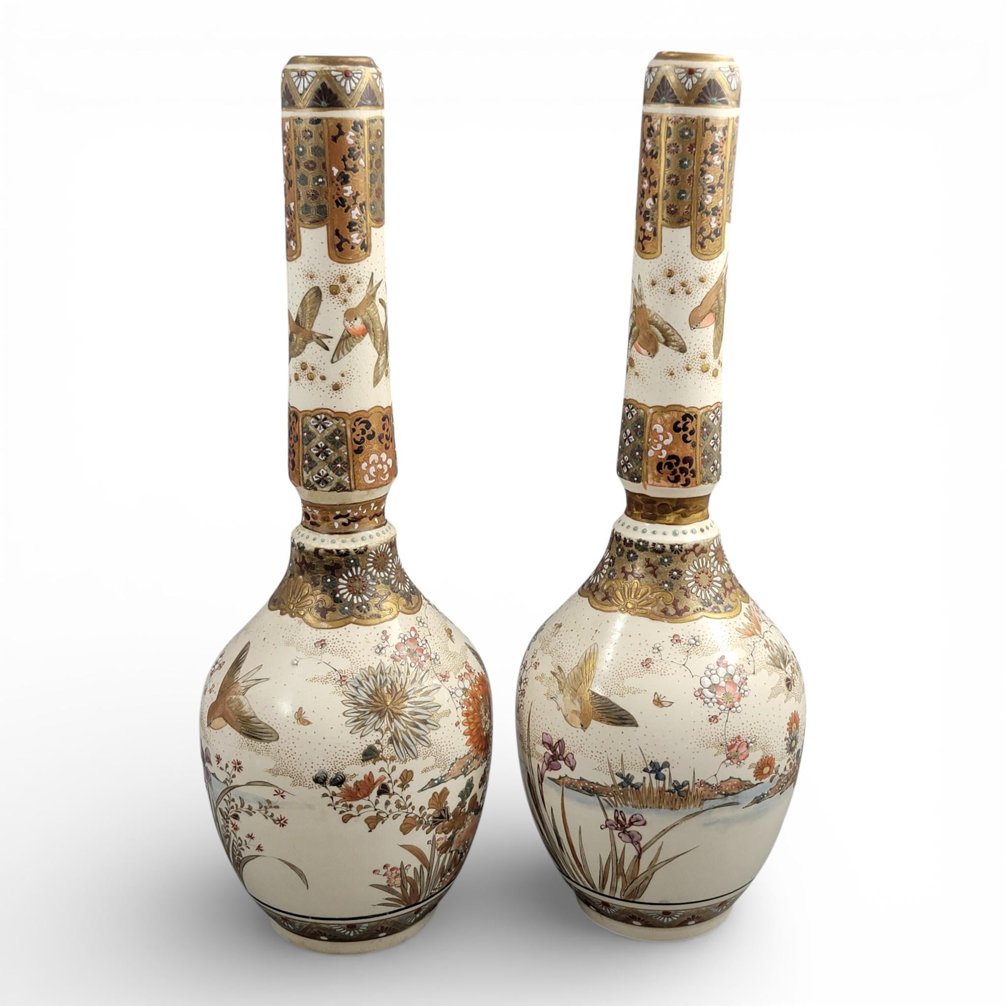Rare pair of large Japanese Satsuma vases of elongated bottle form, dating to the Meiji period and standing approximately 38 cm high.