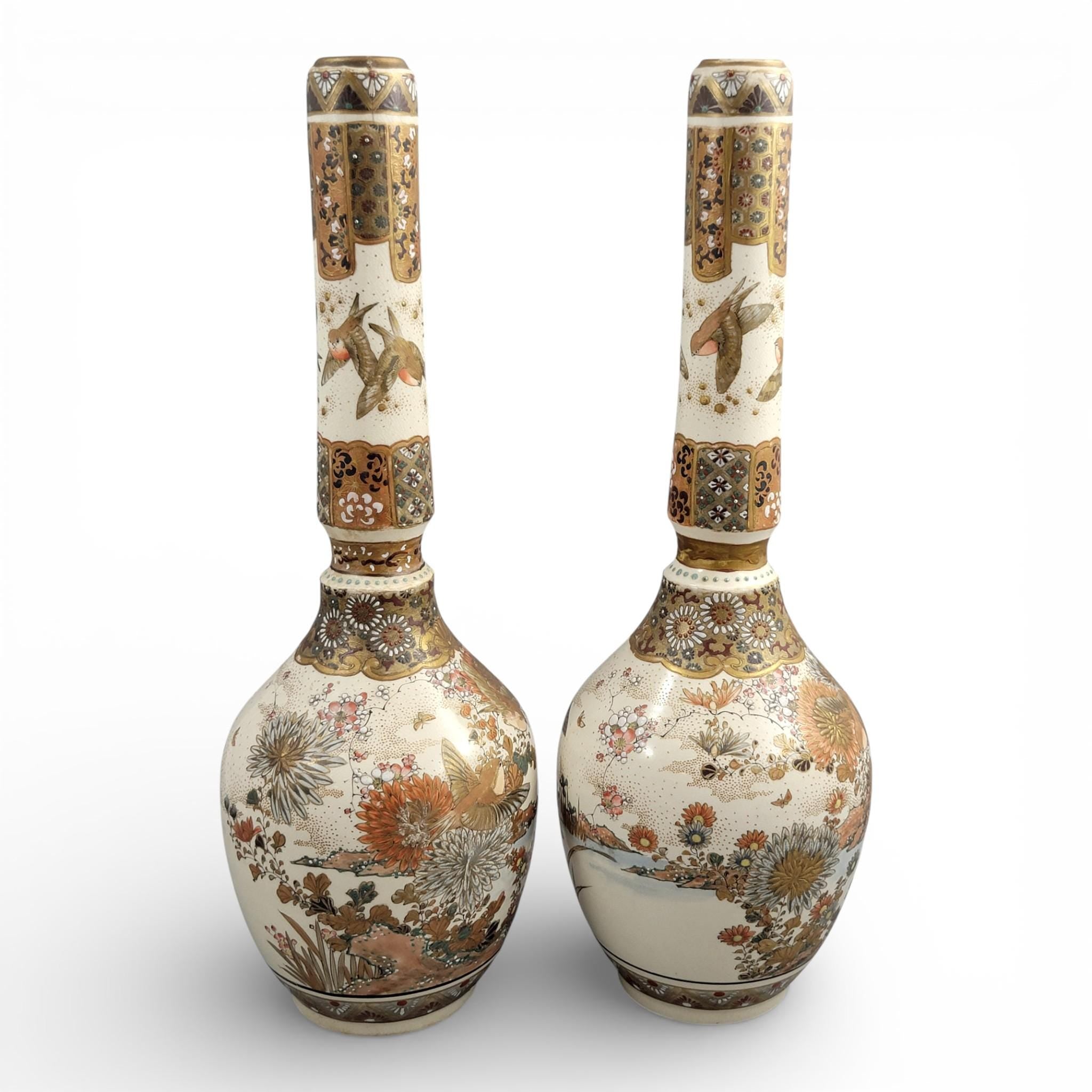 Rare pair of large Japanese Satsuma vases of elongated bottle form, dating to the Meiji period and standing approximately 38 cm high.
