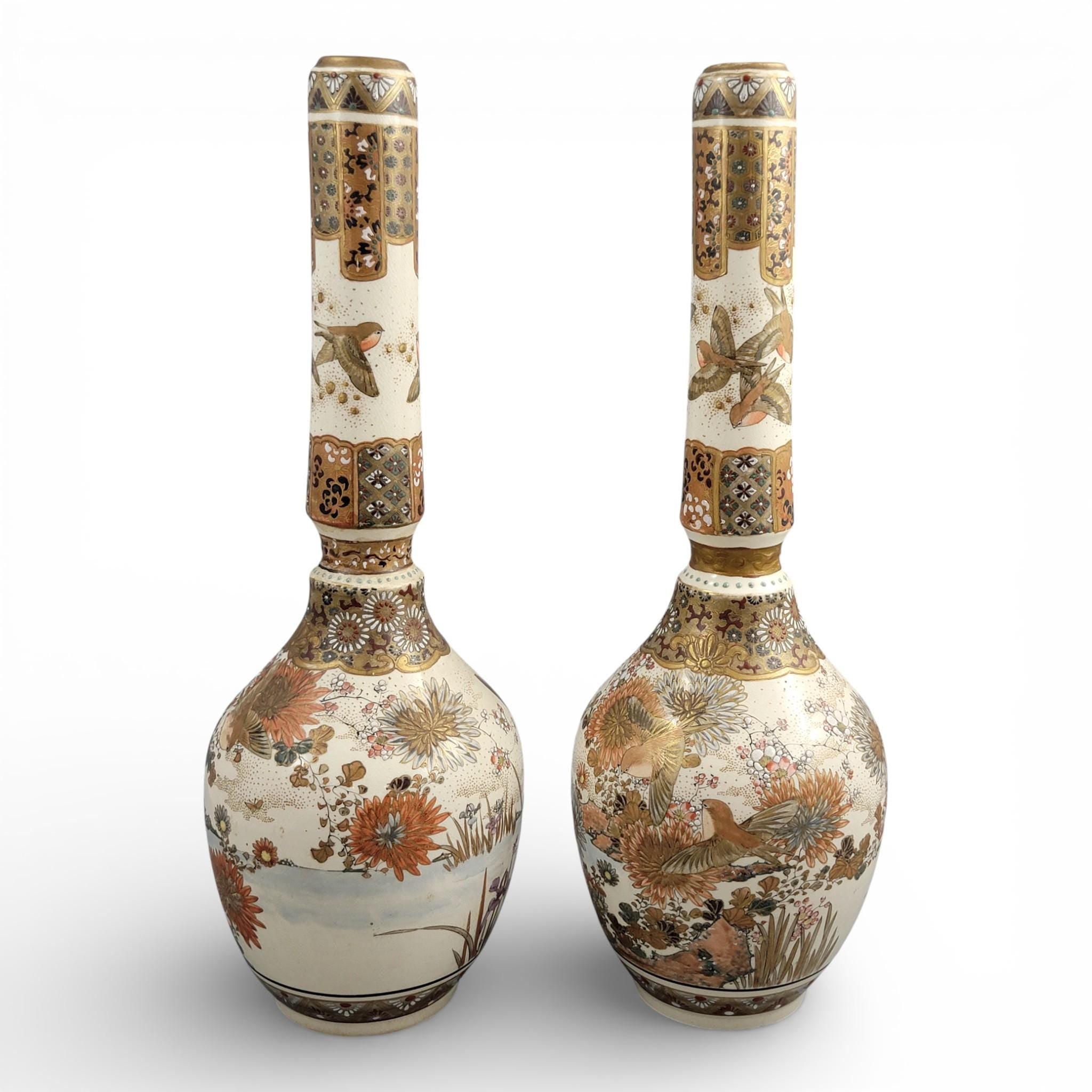 Rare pair of large Japanese Satsuma vases of elongated bottle form, dating to the Meiji period and standing approximately 38 cm high.