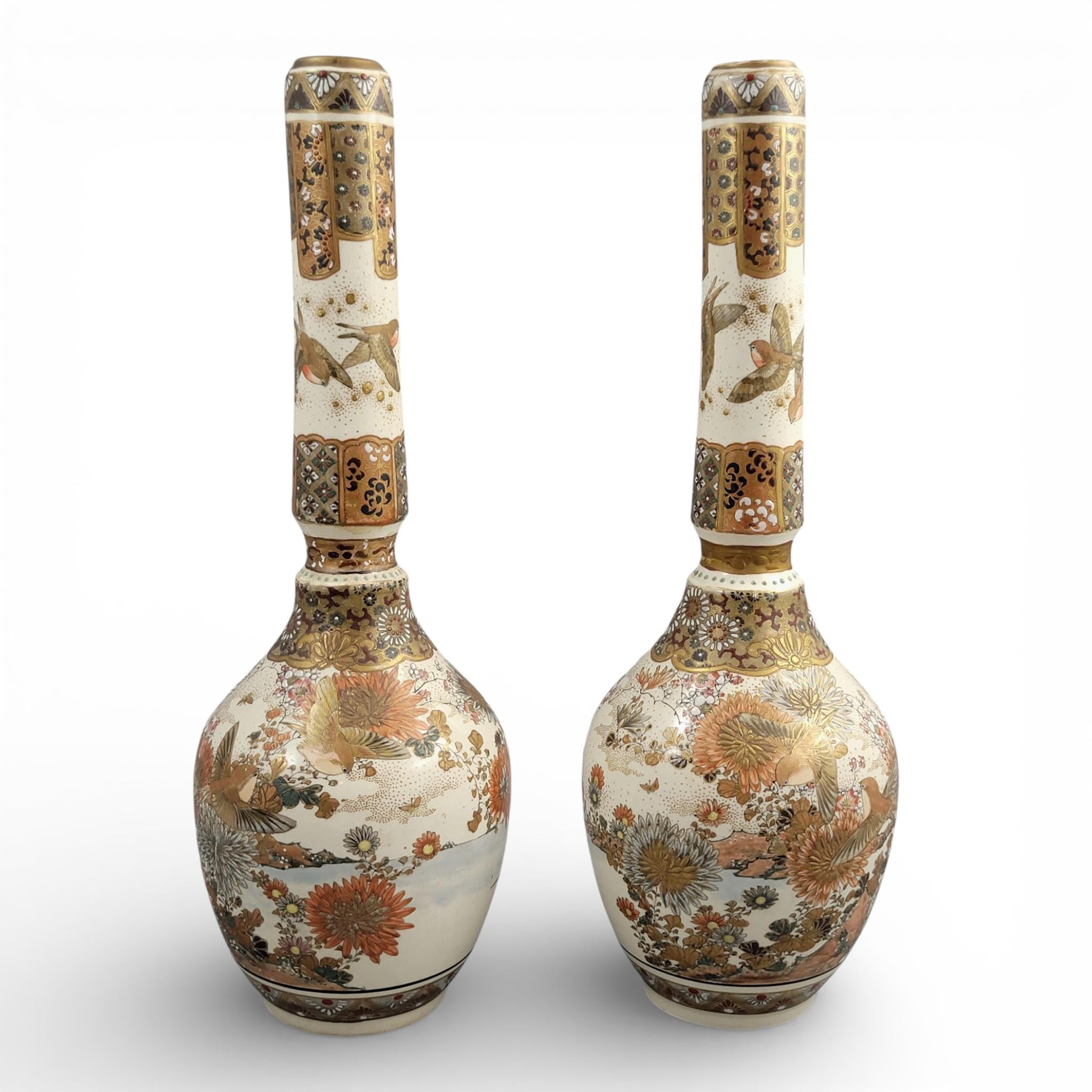 Rare pair of large Japanese Satsuma vases of elongated bottle form, dating to the Meiji period and standing approximately 38 cm high.