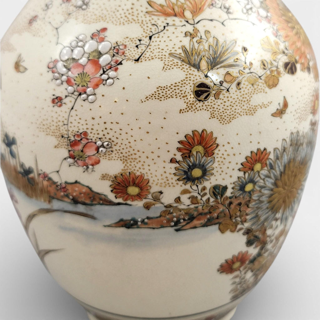 Rare pair of large Japanese Satsuma vases of elongated bottle form, dating to the Meiji period and standing approximately 38 cm high.