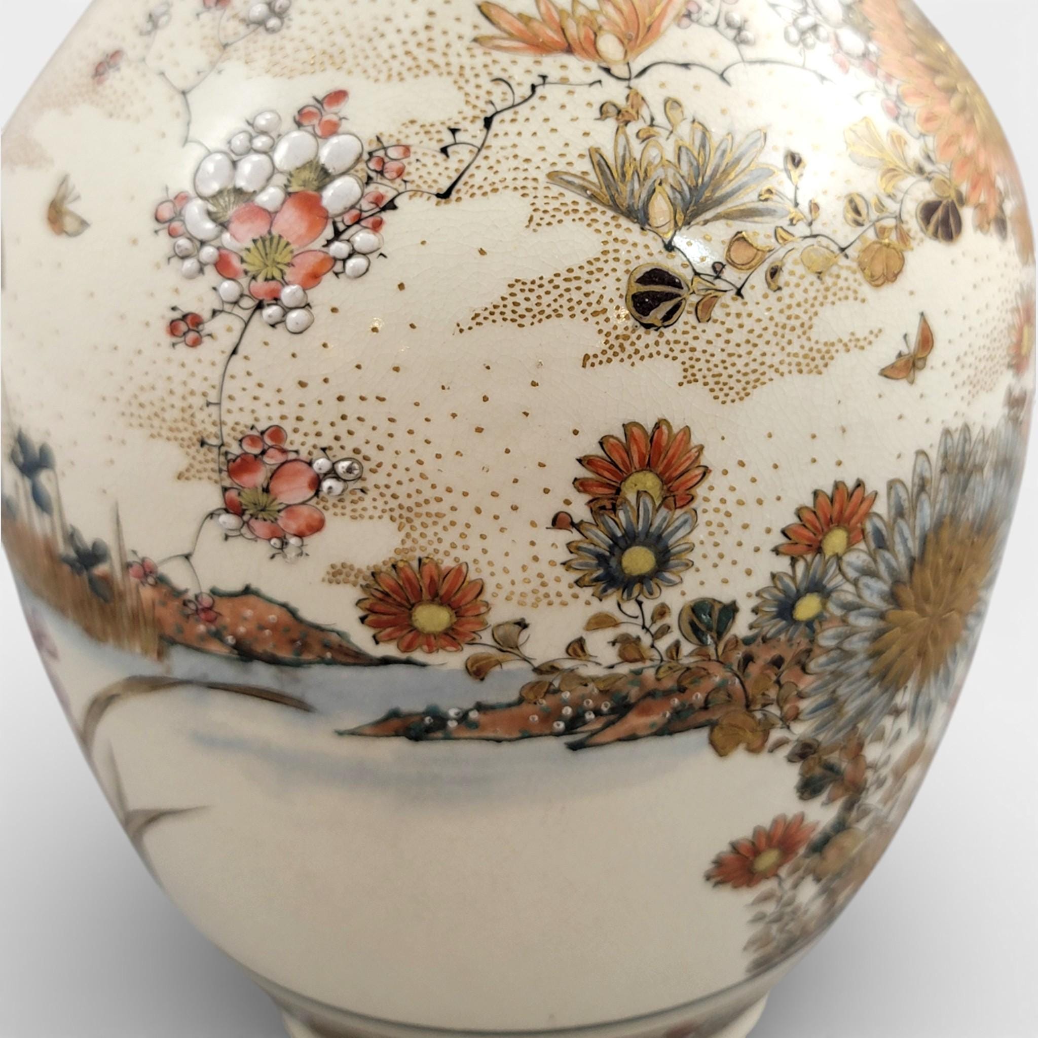Rare pair of large Japanese Satsuma vases of elongated bottle form, dating to the Meiji period and standing approximately 38 cm high.