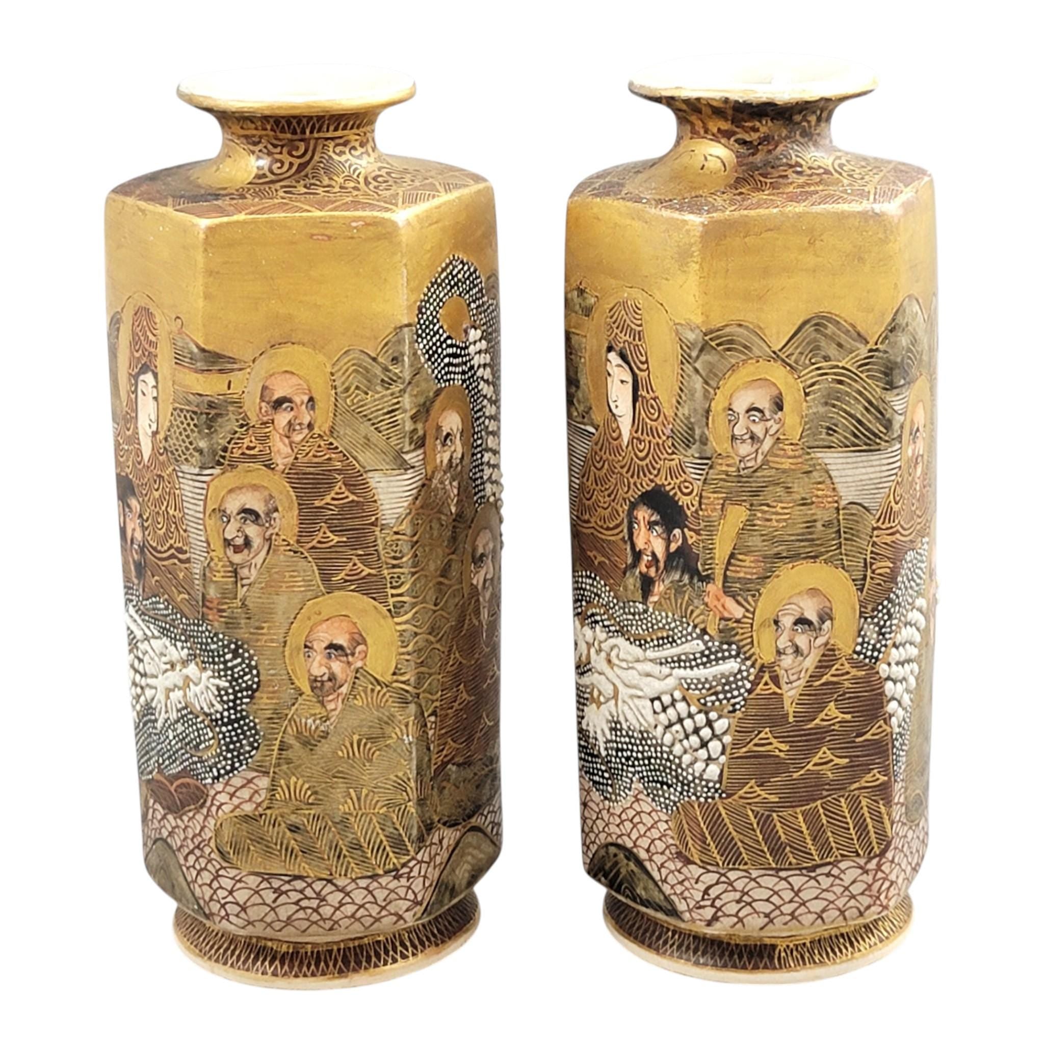 Pair of Japanese Satsuma vases with Rakan, dragon and moriage, Meiji–Taisho period