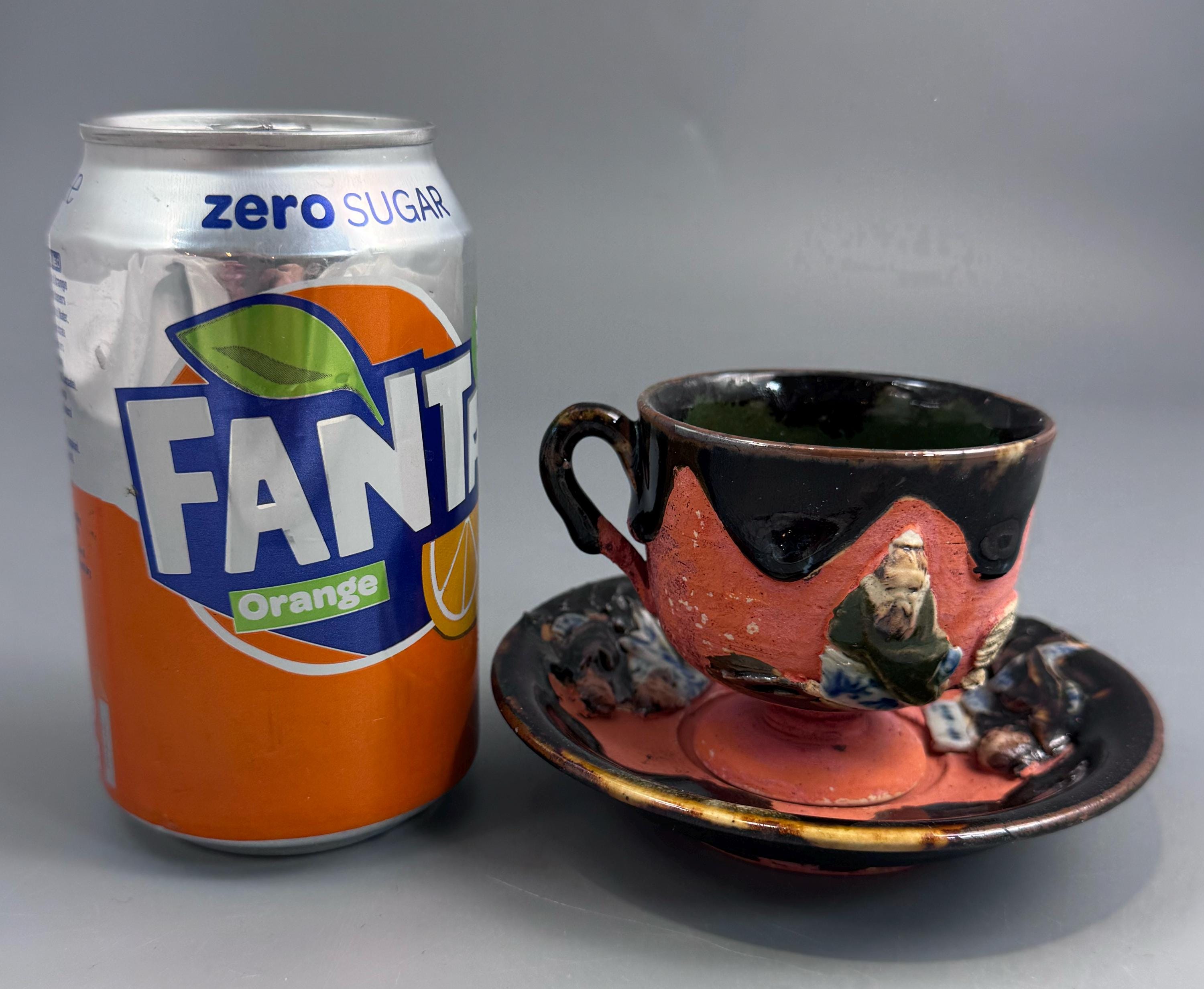 Japanese Sumida Gawa Cup and Saucer with Applied Sage Figures, Attributed to Ishiguro Kōko — Meiji / Early Taishō Period